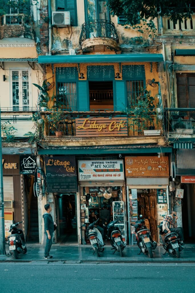 Motorbikes are parked outside some shops