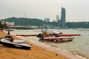 a boat by the beach in pattaya