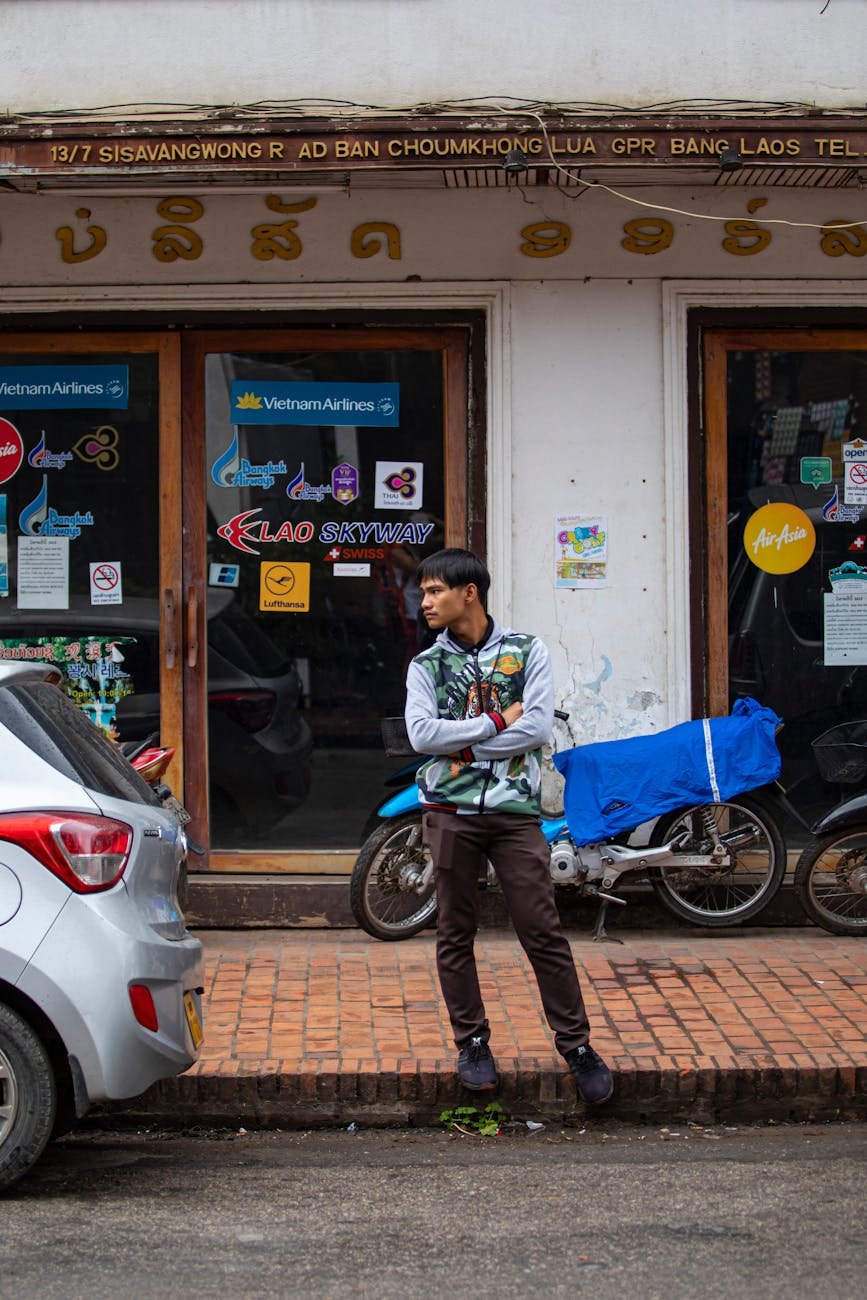a man standing on the sidewalk by the building