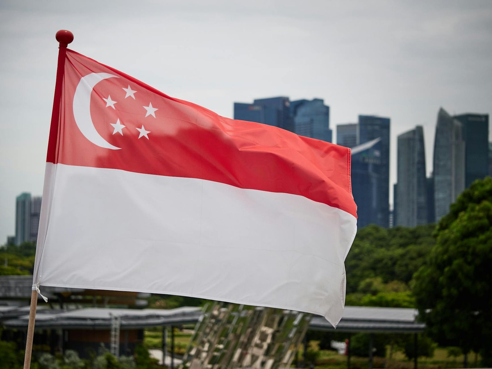 singapore flag with city skyline background