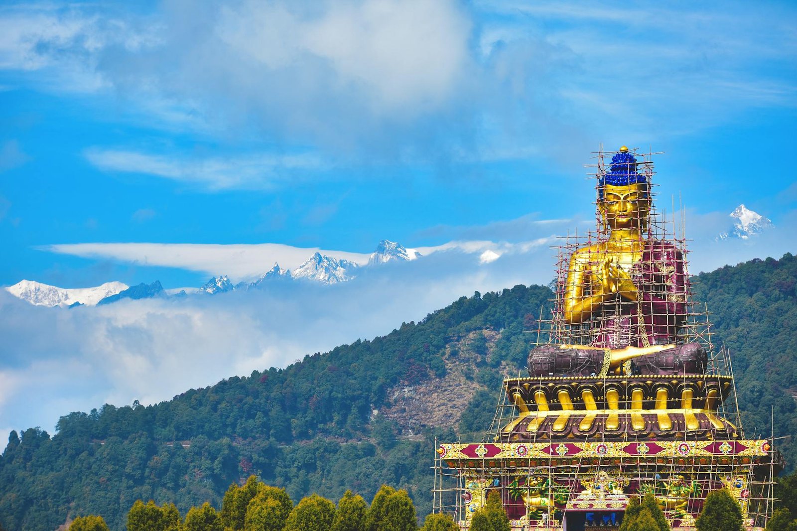 golden buddha statue in ravangla with mountain view